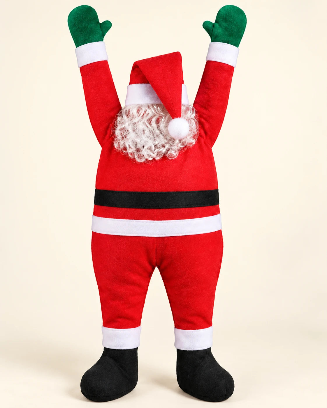 Hanging Santa on a plain cream background: red felt suit with white trim, black belt, black boots, green mittens and a white curly beard under a red hat